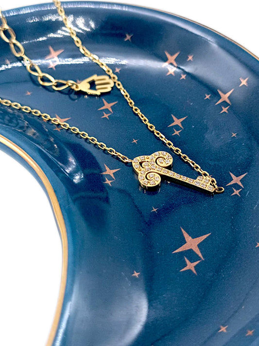 Gourmette à chaine fine clé céleste dorée sertie de zircons . Charme main de fatima . Gémaux maroc .